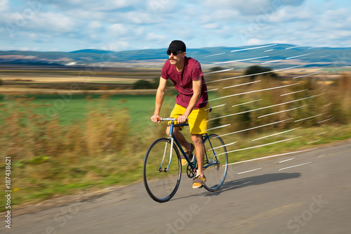 Casual cyclist riding bicycle very fast