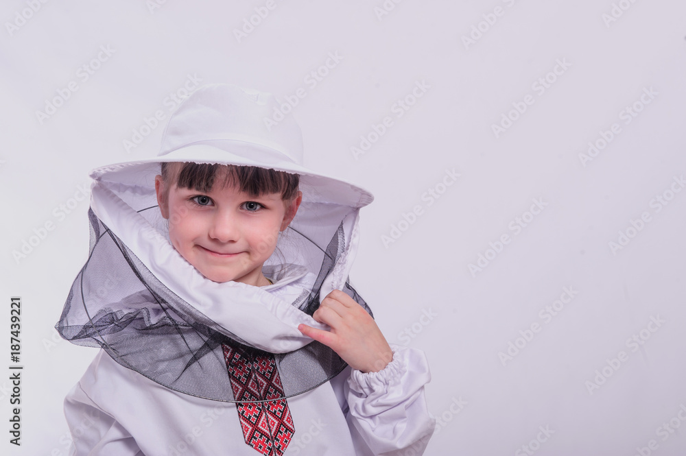 A little girl wears an over sized bee suit in studio white background. A little girl wears an over sized bee suit in studio white background.