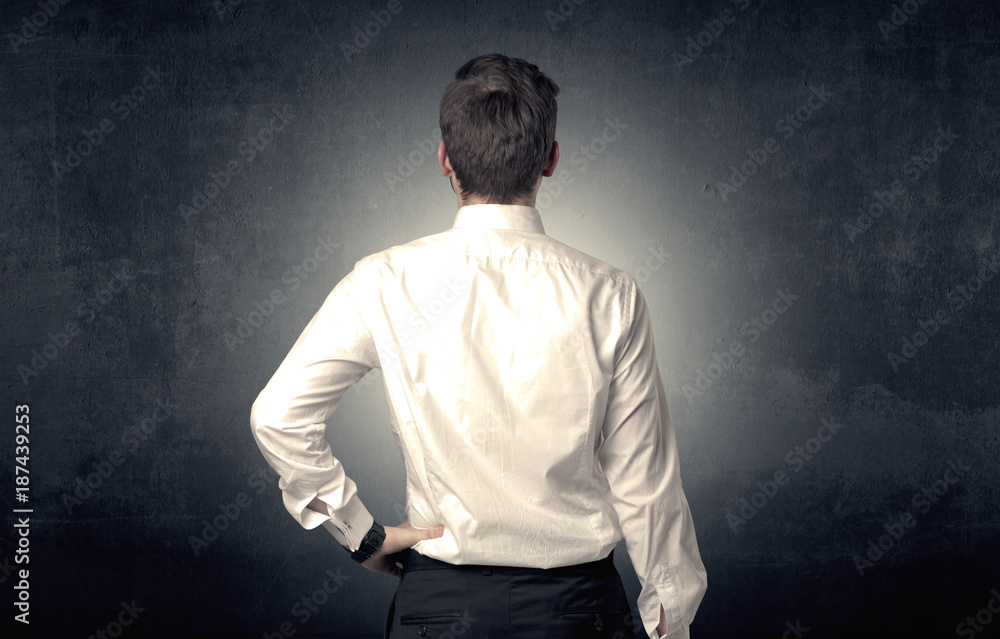 Businessman standing and thinking Businessman standing and thinking