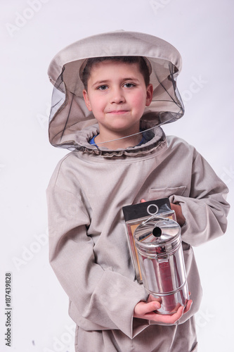 Kid in beekeeper's suits posing in studio white background. photo