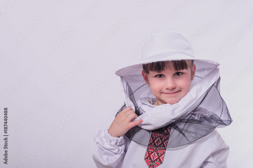 Kid in beekeeper's suits posing in studio white background. Kid in beekeeper's suits posing in studio white background.