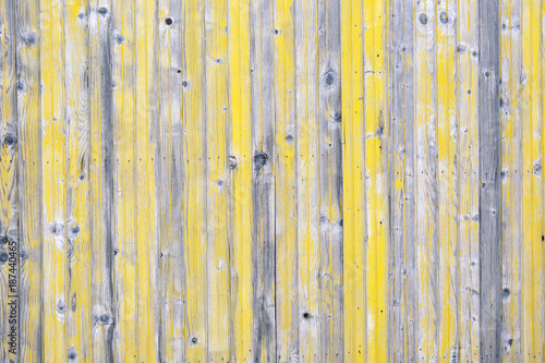 Wooden background with gray and yellow peeled paint