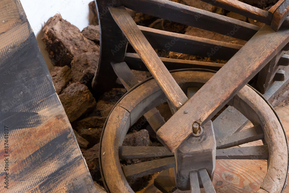 Old wheel on a wheelbarrow