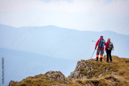 adventure, travel, tourism, hike and people concept - smiling couple walking with backpacks outdoors