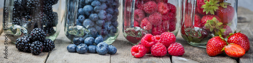 Berries in glass jars - homemade jam, smoothie, low fat dessert