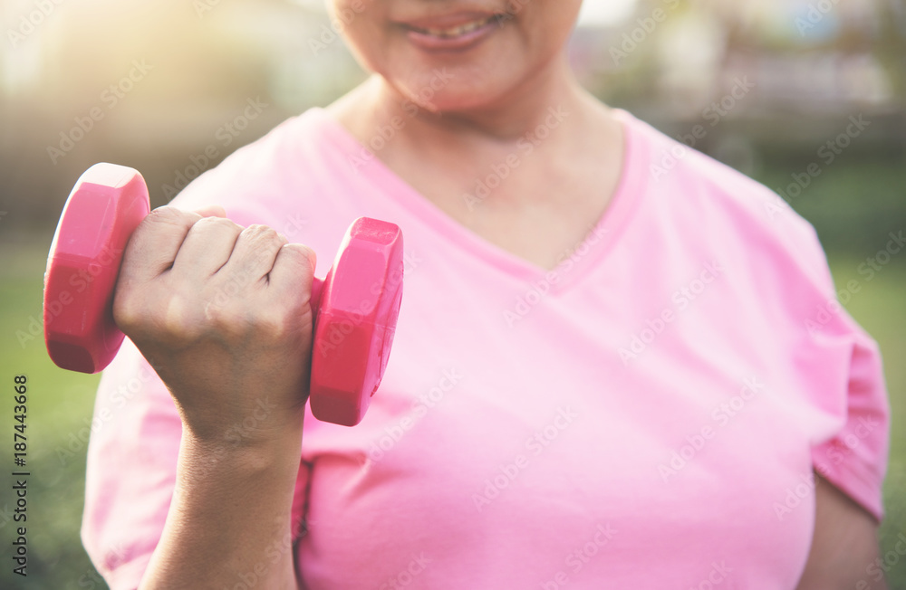 Asian Senior female lifting dumbbell. Asian Senior female lifting dumbbell.