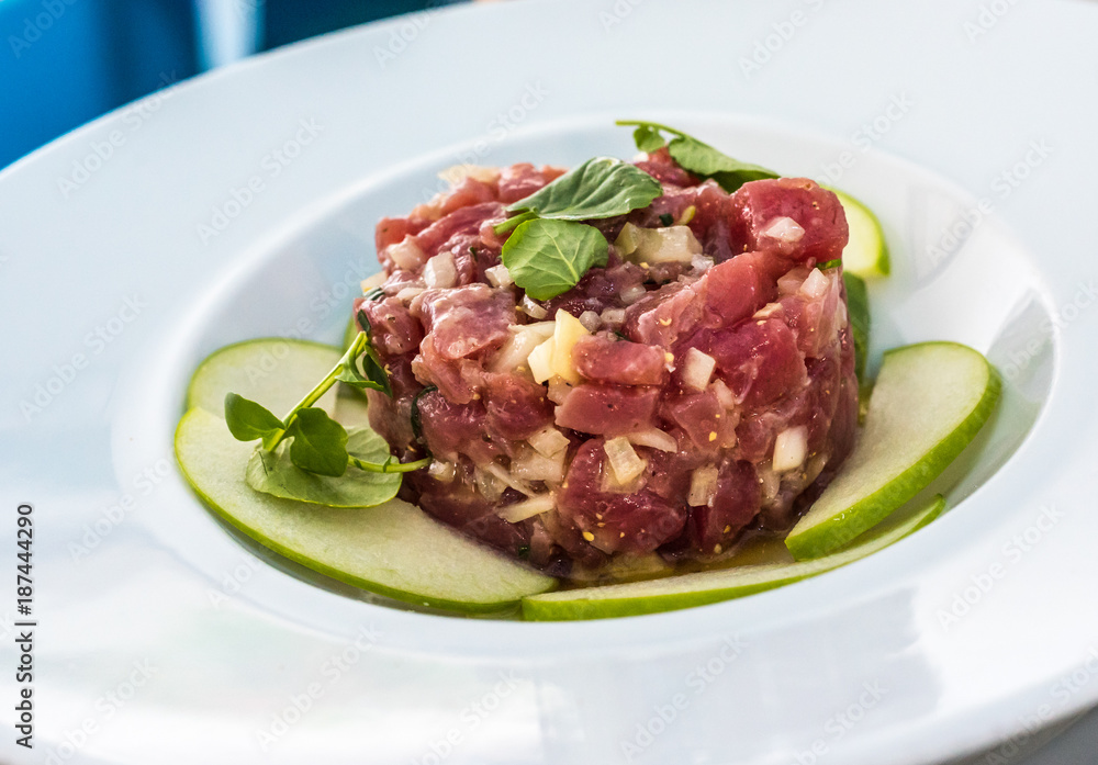 A plate of delicious tuna tartare with green apple
