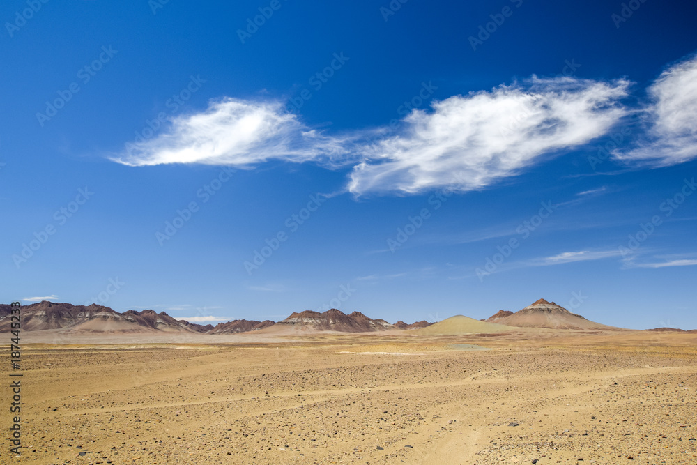 Beautiful wide angle view of the Namibian Desert and mountains in the background at the road between Vioolsdrift and Aussenkehr near the South African border. Blue sky and beautiful clouds. Beautiful wide angle view of the Namibian Desert and mountains in the background at the road between Vioolsdrift and Aussenkehr near the South African border. Blue sky and beautiful clouds.
