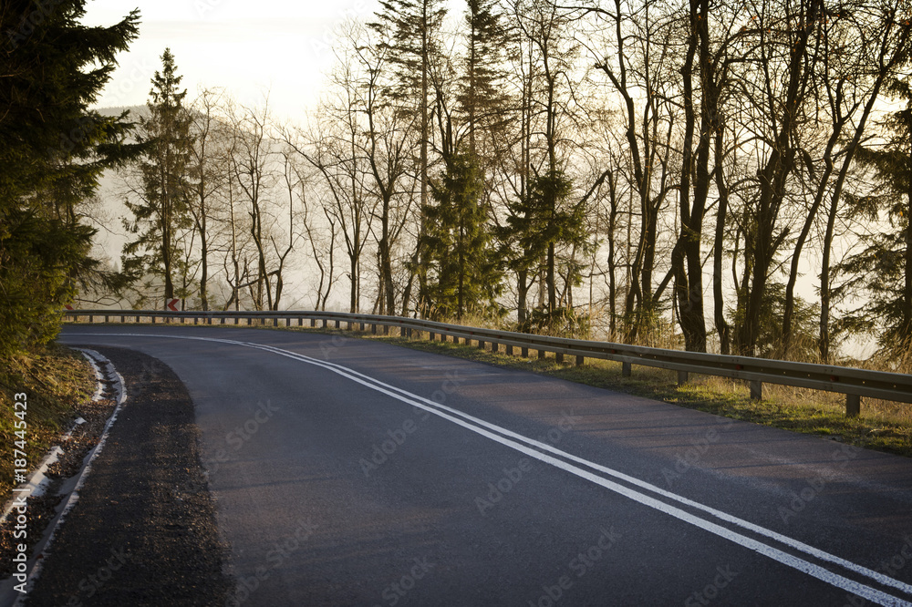 Road in the mountains in the light of the setting sun