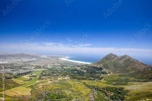 Panoramic view of Noordhoek, a suburb of Cape Town, South Africa, located below Chapman's Peak on the west coast of the Cape Peninsula, and Noordhoek Long Beach. Seen from Silvermine Nature Reserve. photo