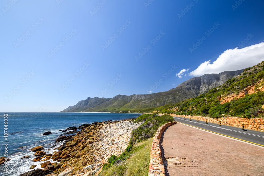 Stunning view of Route 44 in the eastern part of False Bay near Cape Town between Gordon's Bay and Pringle Bay. Hottentots Holland Mountain range in the background. Viewpoint parking bay on right.