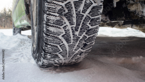 Car tires on winter snowy road