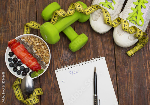 Dumbells, tape measure and healthy food. Fitness