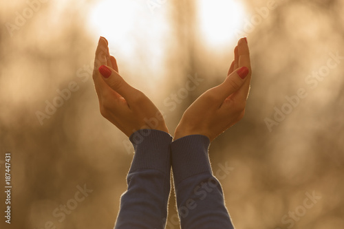 Girl with hands in the air enjoying outdoors.