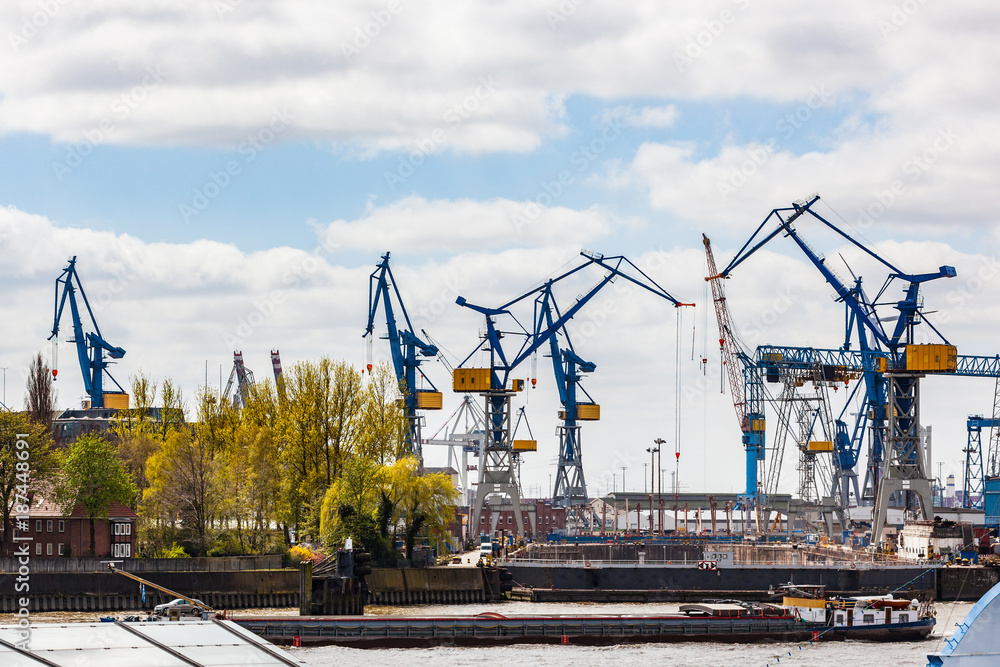 Hamburg freight harbour with cranes loading a ship