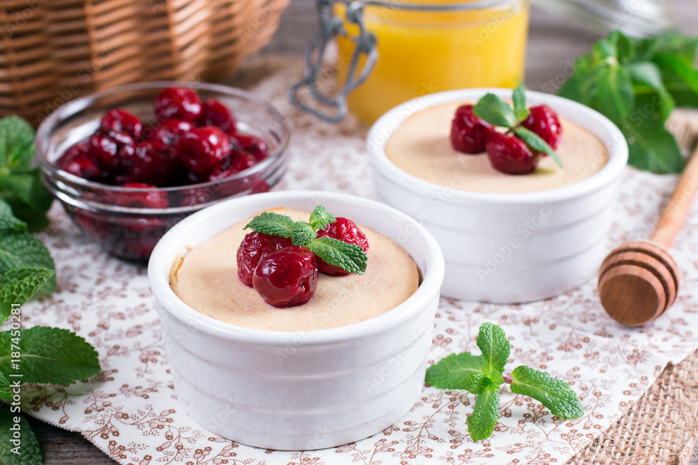 Yoghurt with fresh juicy cherries on a wooden table Yoghurt with fresh juicy cherries on a wooden table