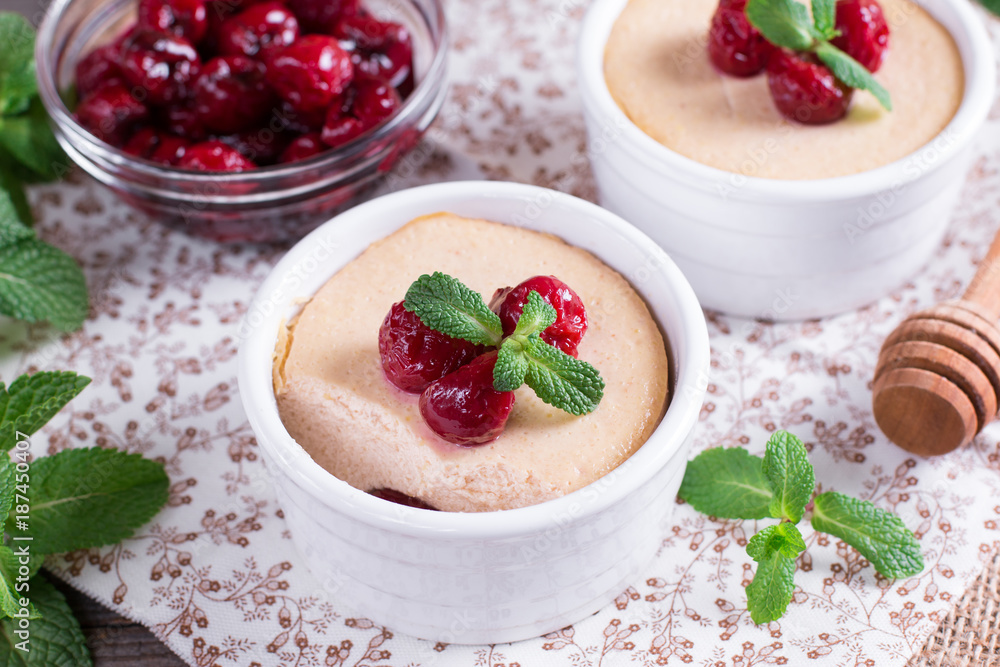 Dessert with cherry in a glass jars on wooden background Dessert with cherry in a glass jars on wooden background