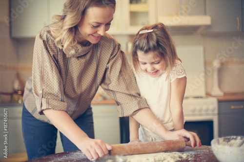 Mother and daughter baking cookies. Family time.