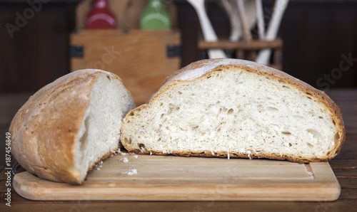 Close up view of an open large loaf of bread in arustic kitchen
