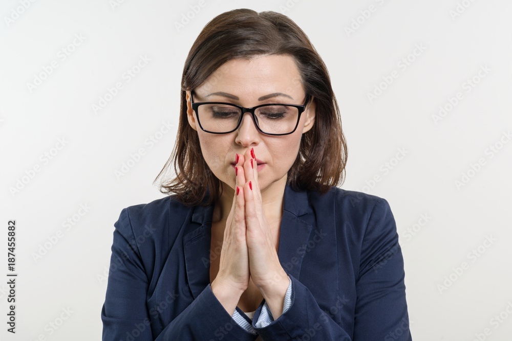 Businesswoman in glasses, closed her eyes and prays, meditates. Businesswoman in glasses, closed her eyes and prays, meditates.