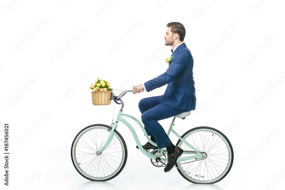 side view of groom in suit riding retro bicycle isolated on white side view of groom in suit riding retro bicycle isolated on white