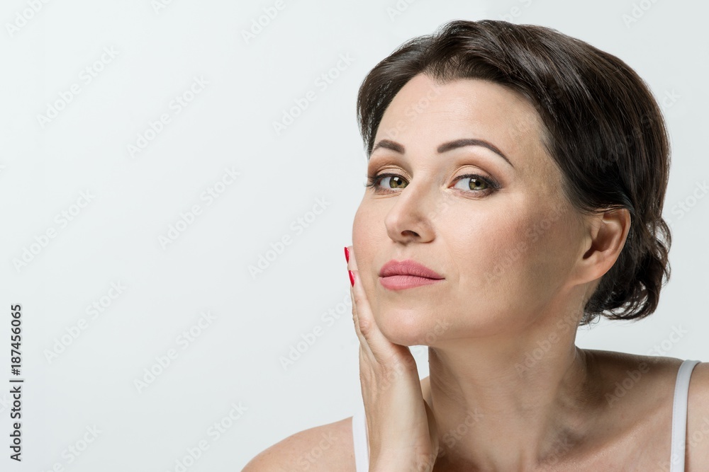 Portrait of mature woman, white studio background, copy space Portrait of mature woman, white studio background, copy space