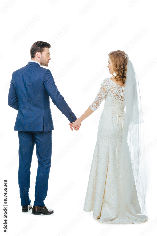back view of beautiful wedding couple holding hands isolated on white