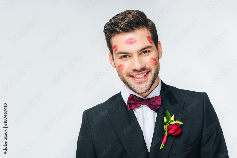 portrait of handsome smiling groom in suit with red lipstick on face portrait of handsome smiling groom in suit with red lipstick on face