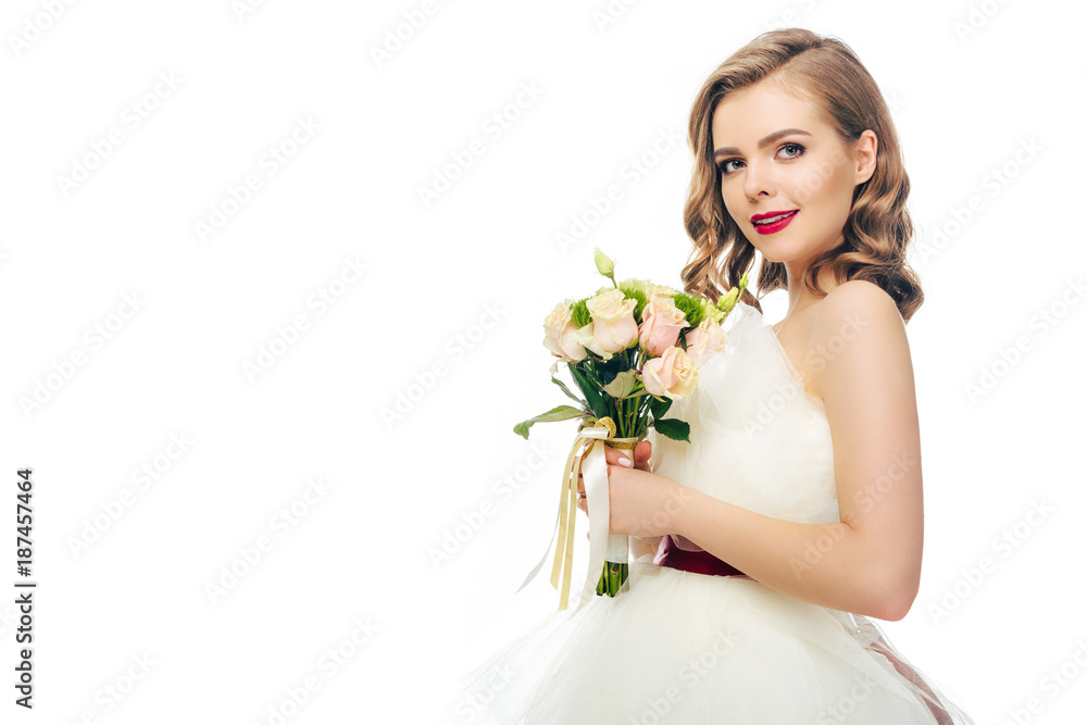 side view of bride in wedding dress with bouquet of flowers in hands isolated on white