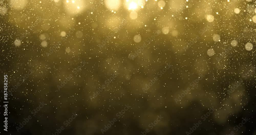 Abstract gold particles of golden glitter fallling down with bright bokeh shine effect. Shimmering and glittering golden light glow glare for luxury premium awarding or Christmas background design