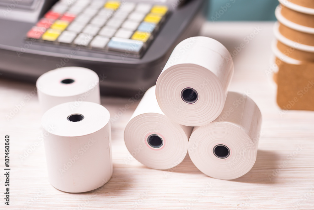 Fototapeta premium Cash register and paper rolls