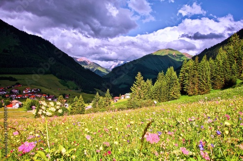 dramatic sky after a storm under a dark blue brooding sky with alpine peaks in Berwang, Tirol