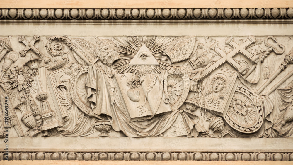 Christian religious symbols with the eye of providence on a 19th century relief in Rome People's Square