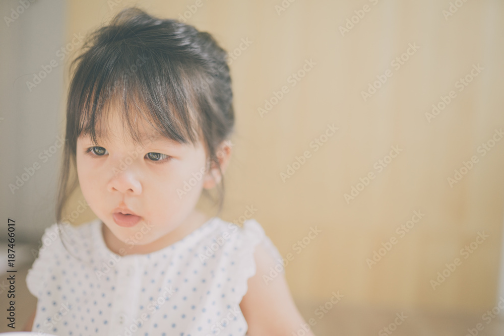 child girl happy look smart phone. asian child.Child development.Little asian girl look smart phone in living room child girl happy look smart phone. asian child.Child development.Little asian girl look smart phone in living room