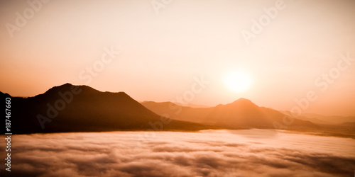 Early morning foggy sunrise on top of mountain soft focus.