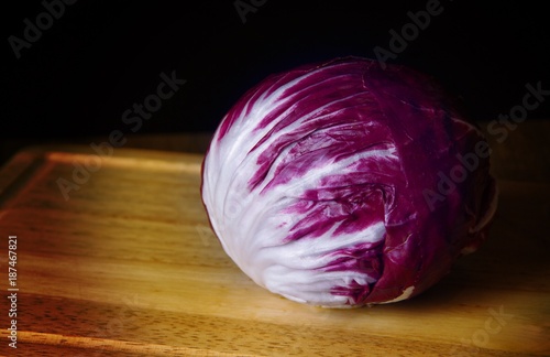 Photos Head of purple radicchio lettuce on cutting board