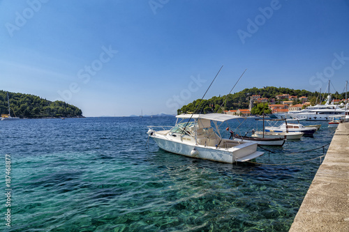 Boats in the crystal clear waters of Cavtat in Croatia.