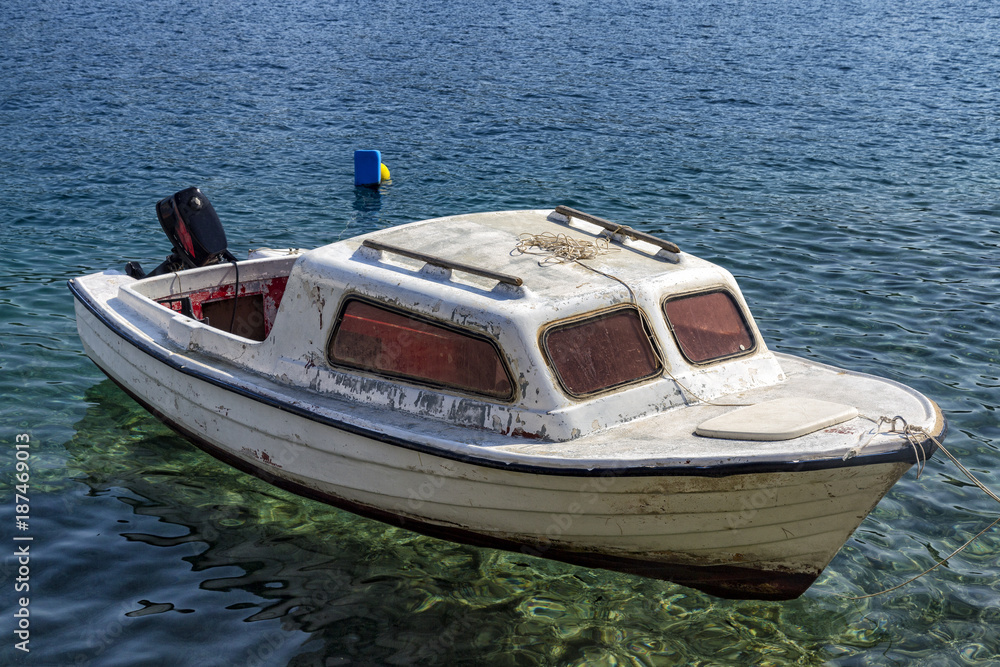 Old boat in the crystal clear waters of Cavtat, Croatia.