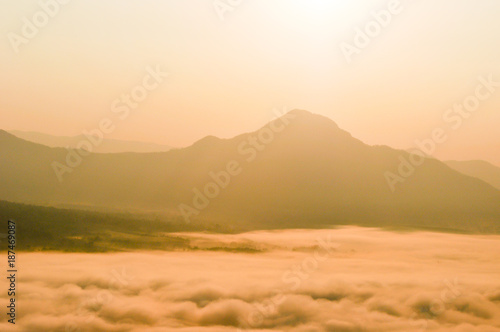Early morning foggy sunrise on top of mountain soft focus.
