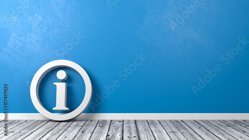 Information Symbol on Wooden Floor Against Wall photo