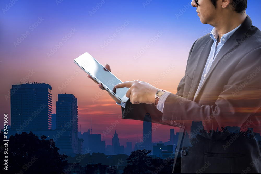 Business Strategy Concept, Businessman touch tablet on hand and city background, Trends for business in high resolution tablet