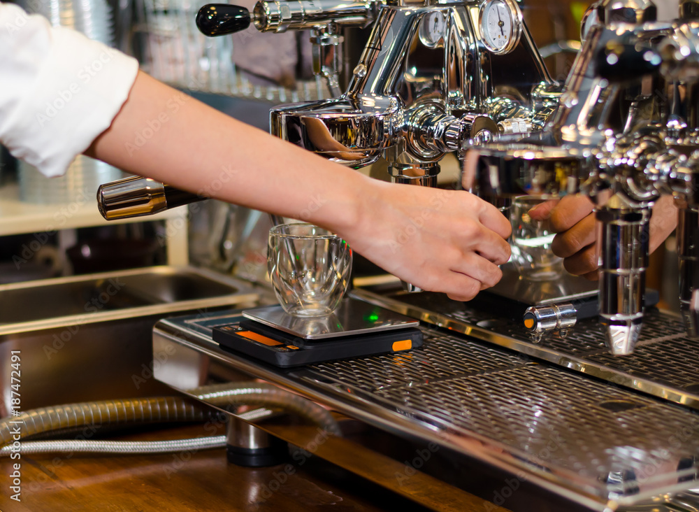 The Barista preparing espresso with machine at coffee shop. start up small business owner food and drink concept The Barista preparing espresso with machine at coffee shop. start up small business owner food and drink concept