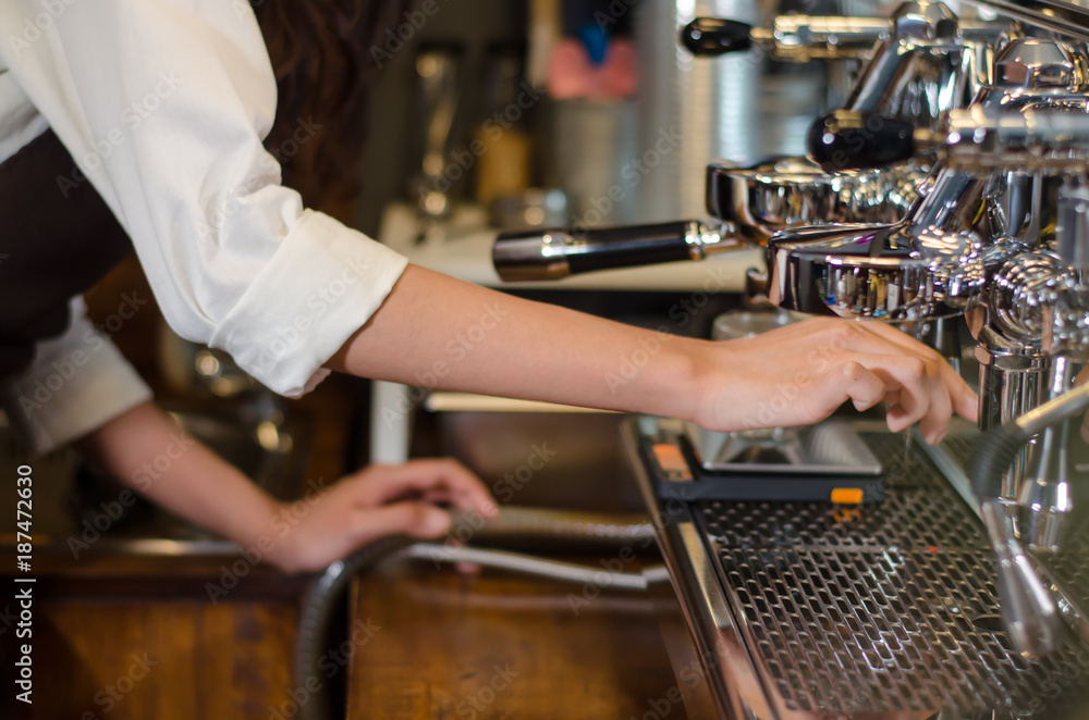 Girl barista bartender waiter in uniform making coffee at the bar Girl barista bartender waiter in uniform making coffee at the bar