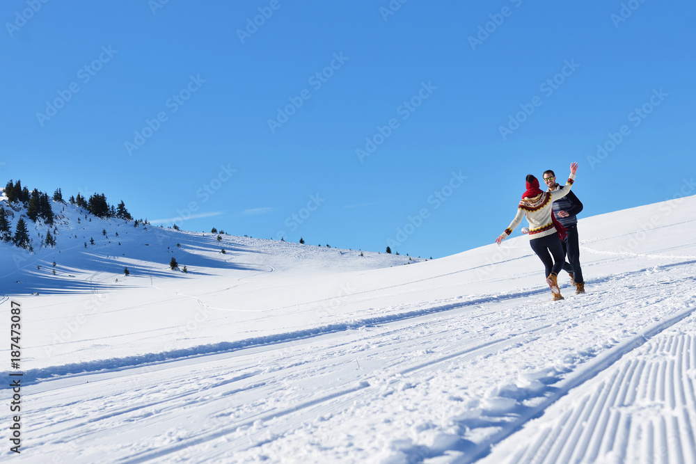 Couple having fun running down slope Couple having fun running down slope