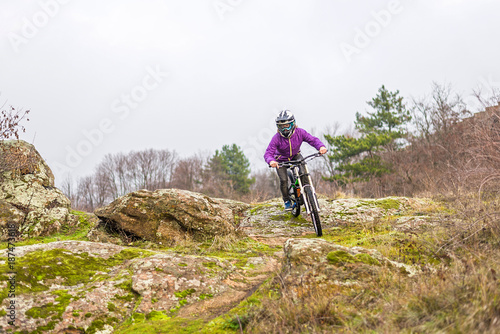 Enduro Cyclist Riding the Mountain Bike on the Rocky Trail, copy of free space.