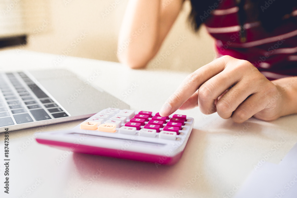 Businesswoman calculate about cost and doing finance at home office, Finance managers task,Concept business and finance investment Businesswoman calculate about cost and doing finance at home office, Finance managers task,Concept business and finance investment