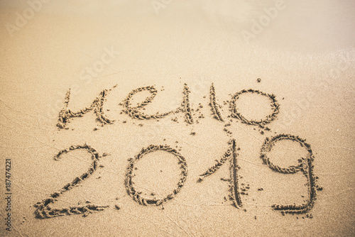 Hello 2019 text written on the sand
