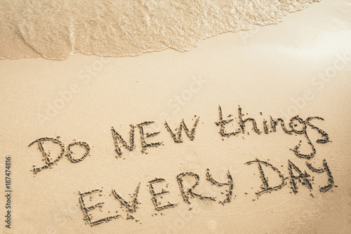 Fotografie, Tablou Do New Things Every Day text written on the sand