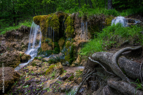 waterfall in the middle of the mountains photo