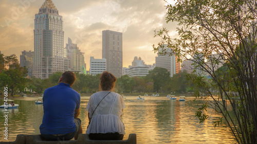 two people sitting look to cityscape